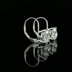 May include: A pair of gold hoop earrings with a large, clear, round gemstone in the center of each hoop.