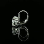 May include: A pair of gold earrings with three round diamonds. The earrings have a hinged post and a push-back closure.